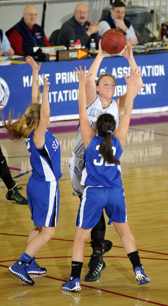 Staff photo by Joe Phelan Searsport's Allison Walker, left, and Brittany Ward double up on Rangeley junior center Taylor Esty during a Class D West semi-final game on Thursday February 20, 2014 at the Augusta Civic Center.