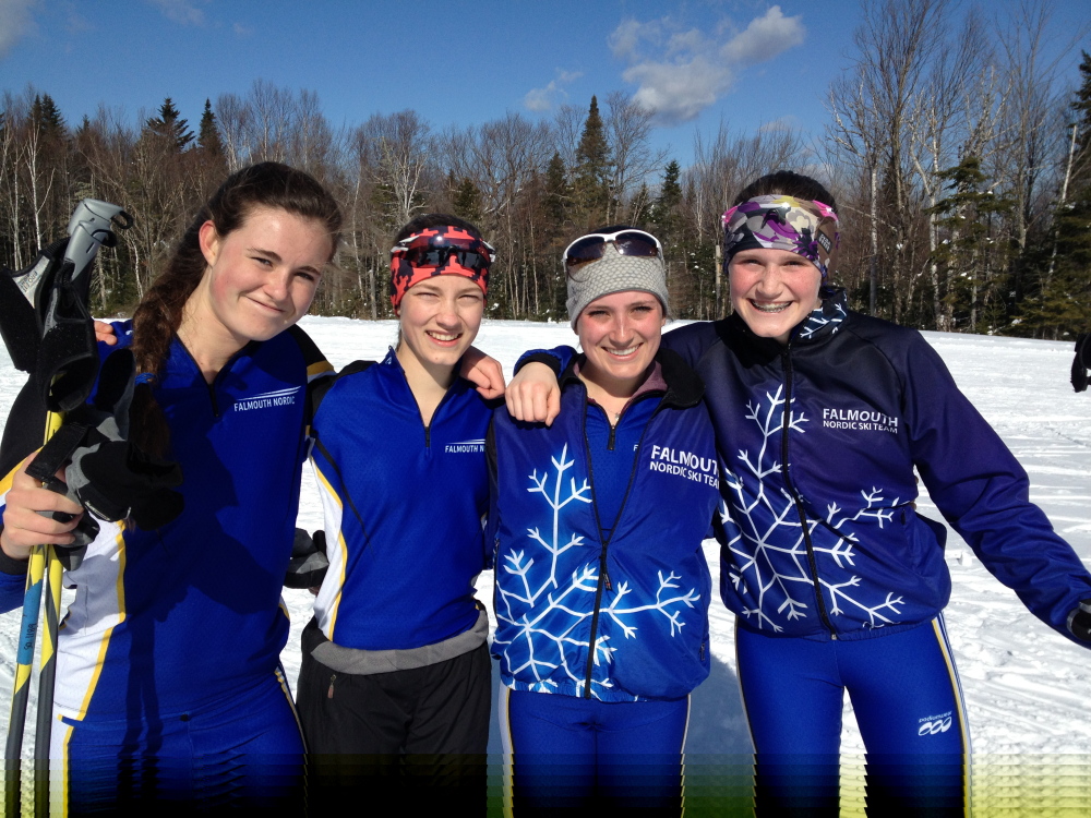 Lucy Mahoney, left, London Bernier, Anna Morin and Gabby Farrell of Falmouth celebrate their girls’ Class A Nordic skiing championship Thursday at the Rangeley Lakes Trail Center.