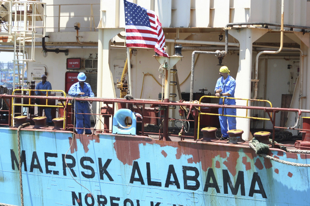 Crew members work aboard the U.S.-flagged Maersk Alabama after the ship docked in the harbour of Mombasa, Kenya, in this Nov. 22, 2009, photo.