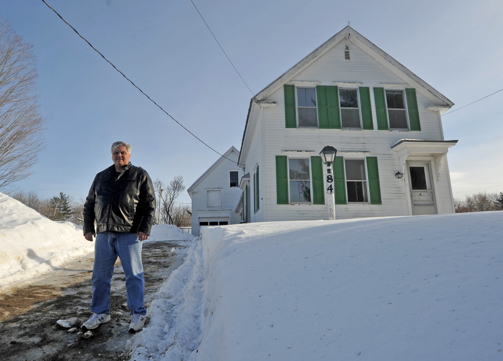 NEW SHELTER: The Rev. Richard Berry stands on Thursday outside a newly acquired home that will be used as a shelter for families at Trinity Evangelical Free Church in Skowhegan.