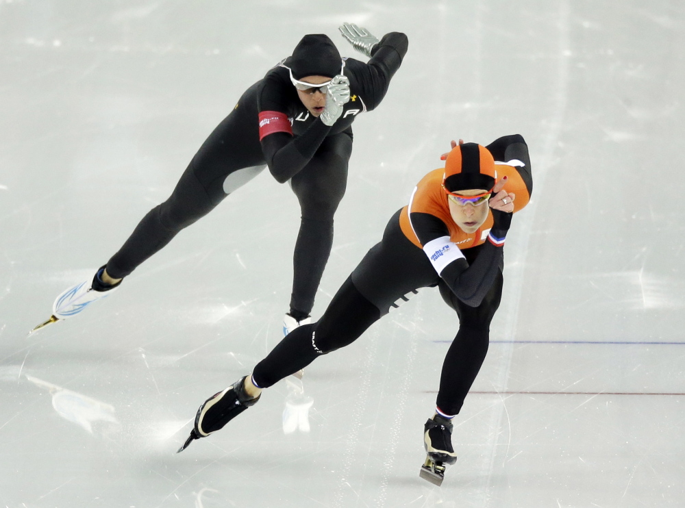 Brittany Bowe of the United States, left, trails silver medalist Ireen Wust of the Netherlands in the women’s 1,000-meter speedskating race during the 2014 Winter Olympics in Sochi, Russia. After a strong season on the World Cup circuit, the U.S. speedskating team has had a miserable performance in Sochi – and much of the speculation turned to the new Under Armour skinsuit developed with help from aerospace and defense giant Lockheed Martin.