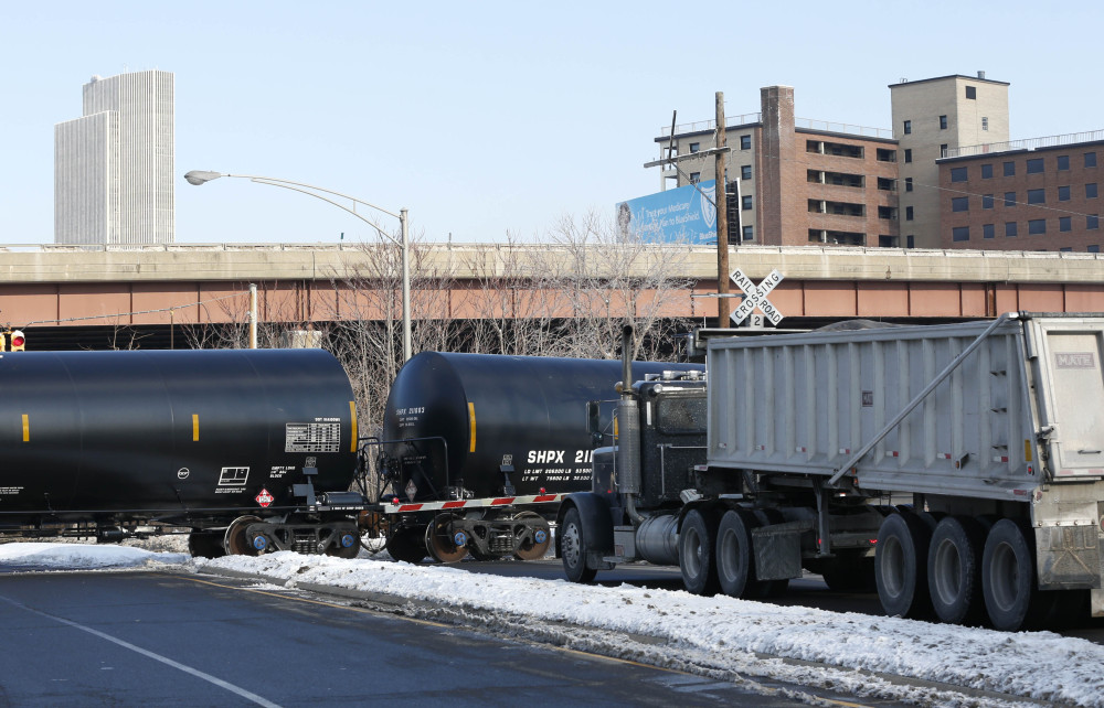 A truck waits as railroad oil tanker cars arrive at the Port of Albany recently. The Port of Albany has become a hub for the U.S. oil business, taking shipments from North Dakota’s Bakken Shale daily by mile-long trains and shipping it in tankers down the Hudson River to refineries.