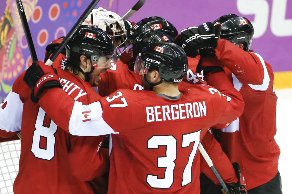 Team Canada celebrates its 1-0 victory over the United States in the men’s semifinal ice hockey game at the 2014 Winter Olympics on Friday in Sochi, Russia.