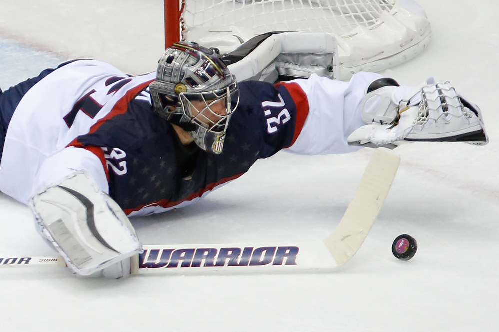 American goaltender Jonathan Quick dives for the puck during the second period of the men’s semifinal ice hockey game at the 2014 Winter Olympics on Friday in Sochi, Russia.