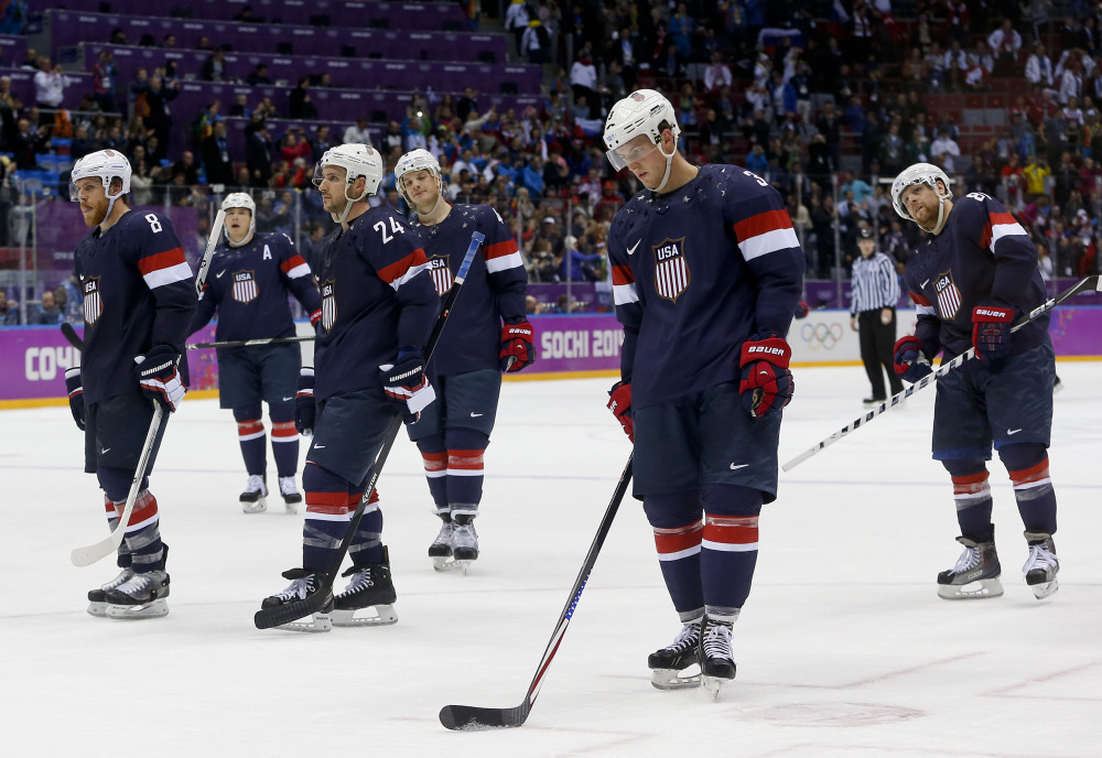 Team USA skates off the ice after losing 5-0 to Finland in the men’s bronze medal hockey game Saturday at the 2014 Winter Olympics in Sochi, Russia.