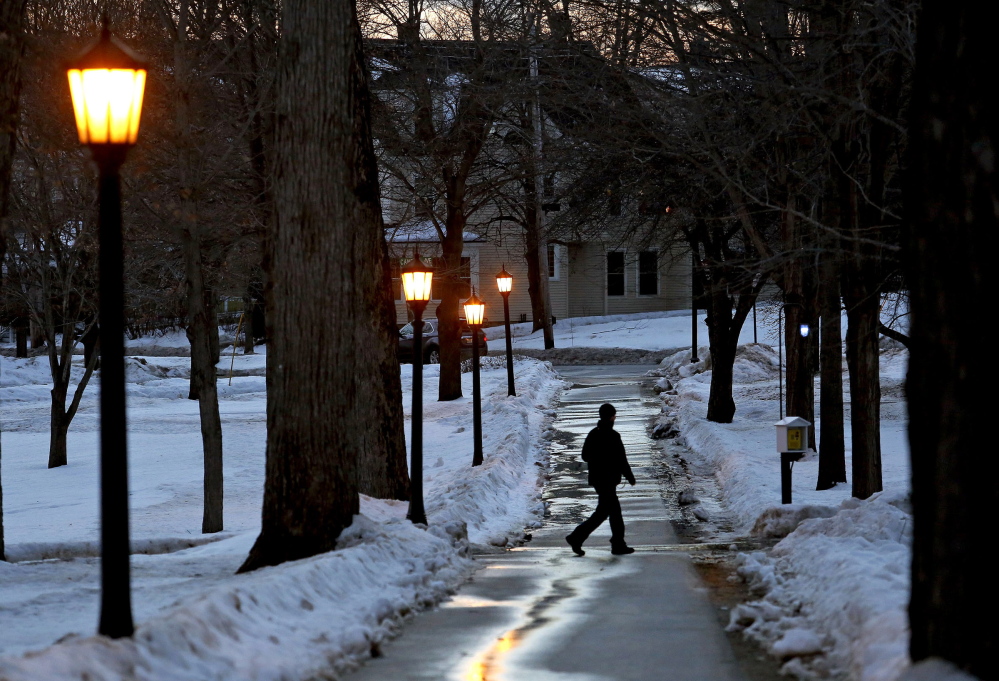 A man strolls on the Bates College campus in Lewiston at dusk Saturday. A student from the college, John Durkin, was found dead in Rome, where he was studying. In a statement, Bates president Clayton Spencer said: “This is a time of deep sadness for our community and for so many people who knew and loved John.”