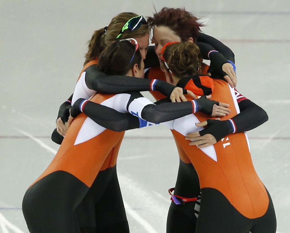 Speedskaters from the Netherlands celebrate taking the gold medal on the women’s team pursuit Saturday at the Adler Arena Skating Center at the 2014 Winter Olympics in Sochi, Russia.