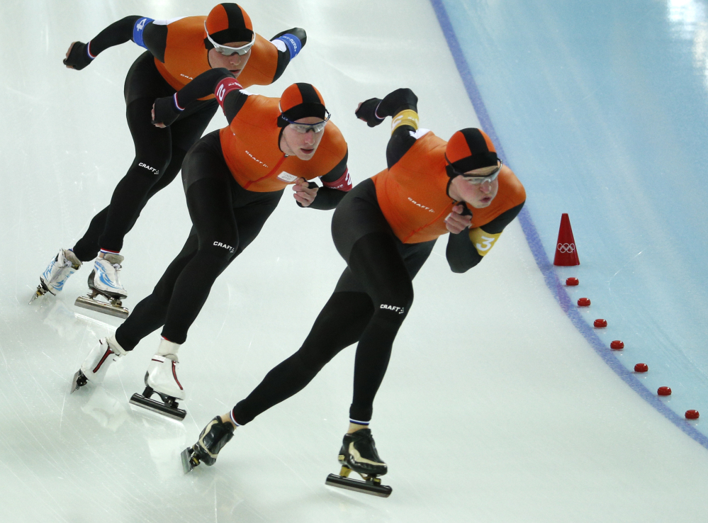 Speedskaters from the Netherlands, left to right, Koen Verweij, Jan Blokhuijsen and Sven Kramer skate their way to gold in the men’s team pursuit race at the Adler Arena Skating Center Saturday at the 2014 Winter Olympics in Sochi, Russia.