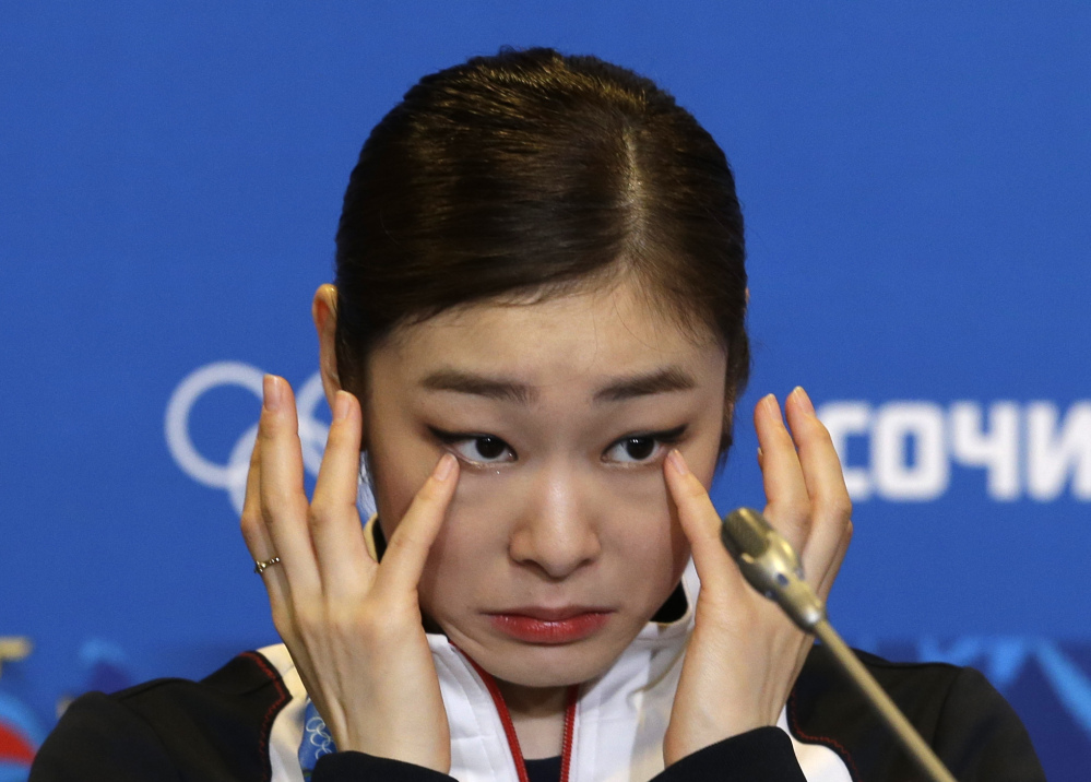 Yuna Kim of South Korea wipes her face as she attends a news conference following the women’s free skate figure skating finals at the Iceberg Skating Palace during the 2014 Winter Olympics on Thursday in Sochi, Russia.