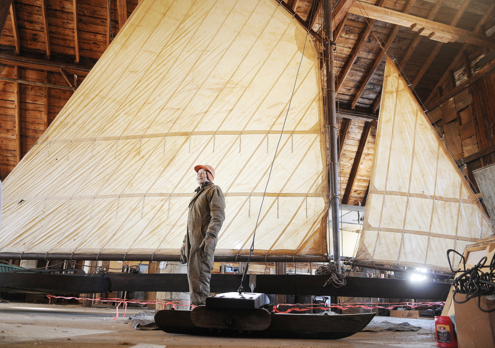 ICE RACER: Lloyd McCabe stands next to the ice boat that was re-assembled on the second floor of the carriage house at the Monmouth Museum. With a mast 25 feet high, McCabe and other volunteers worked for several months to put the craft together after being in storage 35 years.
