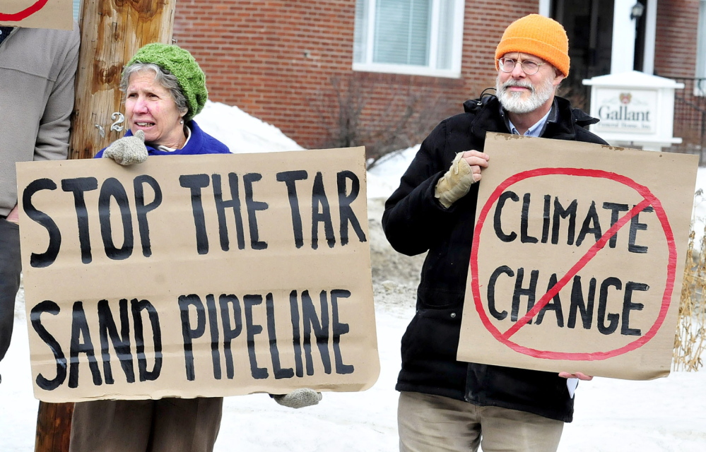 STOP: Marian Flaherty and Dick Thomas were among a group of citizens speaking out against the proposed Keystone XL Pipeline on Sunday, Feb. 23, 2104, in front of the Universalist Unitarian Church in Waterville.