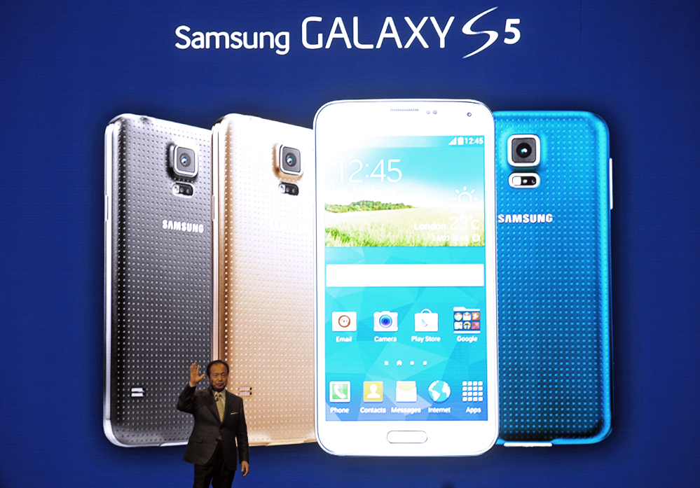 Samsung CEO J.K. Shin presents the new Samsung Galaxy S5 at the Mobile World Congress, the world’s largest mobile phone trade show, in Barcelona, Spain, on Monday.