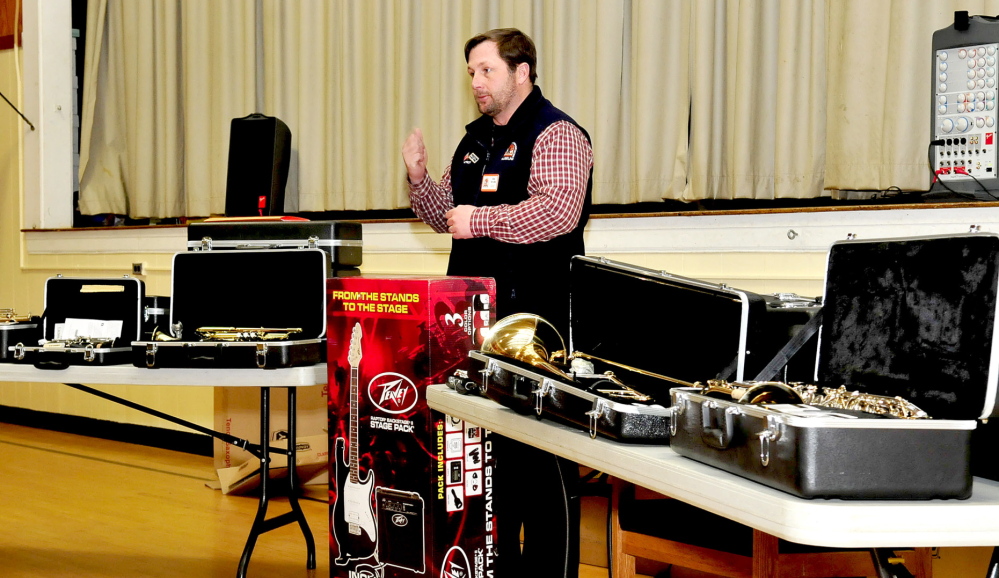 THE BEAT GOES ON: Jim Neville, of the Cole Land Transportation Museum, speaks with Quimby Middle School students Tuesday while donating music instruments to their school.