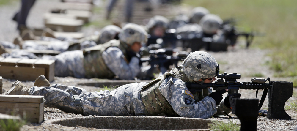 Female soldiers train on a firing range while wearing new body armor in Fort Campbell, Ky., in this 2012 photo.