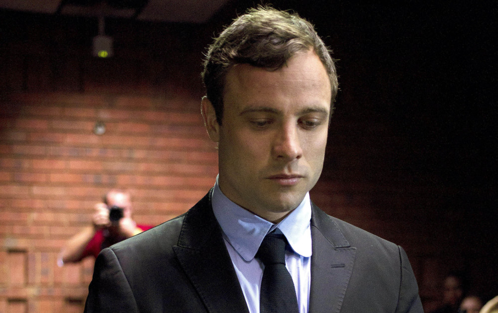 Double-amputee Olympian Oscar Pistorius appears in court to be indicted on charges of murder in the shooting death of Reeva Steenkamp in this Aug. 19, 2013, photo.