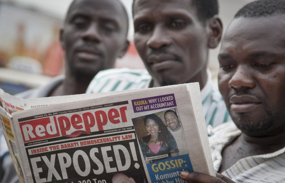 A Ugandan reads a copy of the “Red Pepper” tabloid newspaper in Kampala, Uganda Tuesday, Feb. 25, 2014. The Ugandan newspaper published a list Tuesday of what it called the country’s “200 top” homosexuals, outing some Ugandans who previously had not identified themselves as gay, one day after the president Yoweri Museveni enacted a harsh anti-gay law.