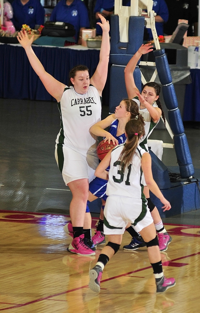 Staff photo by Joe Phelan Carrabec defenders Emma Pluntke, left, (55), Jerzee Rugh (31) and Mickayla Willette swarm Madison's Kirsten Wood during the Class C West girls championship game on Saturday February 22, 2014 at Augusta Civic Center.
