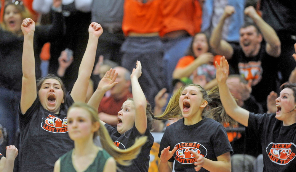 Staff file photo by Michael G. Seamans The Forest Hills High School girls basketball team celebrate their 53-52 win over Rangely last Saturday in Augusta. Kori Coro's buzzer-beating three-pointer sealed victory for the undefeated Tigers.
