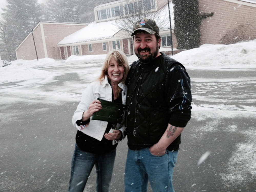 paying it forward: Cathy Landry gives Mark Isbell a hug Wednesday after he shows her where he found her bank bag containing $1,500 cash off Louise Avenue in Waterville.