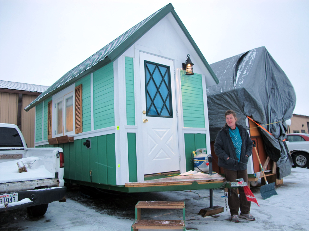 Betty Ybarra, 48, stands outside a tiny houses she and her boyfriend live in, in Madison, Wis. The Associated Press