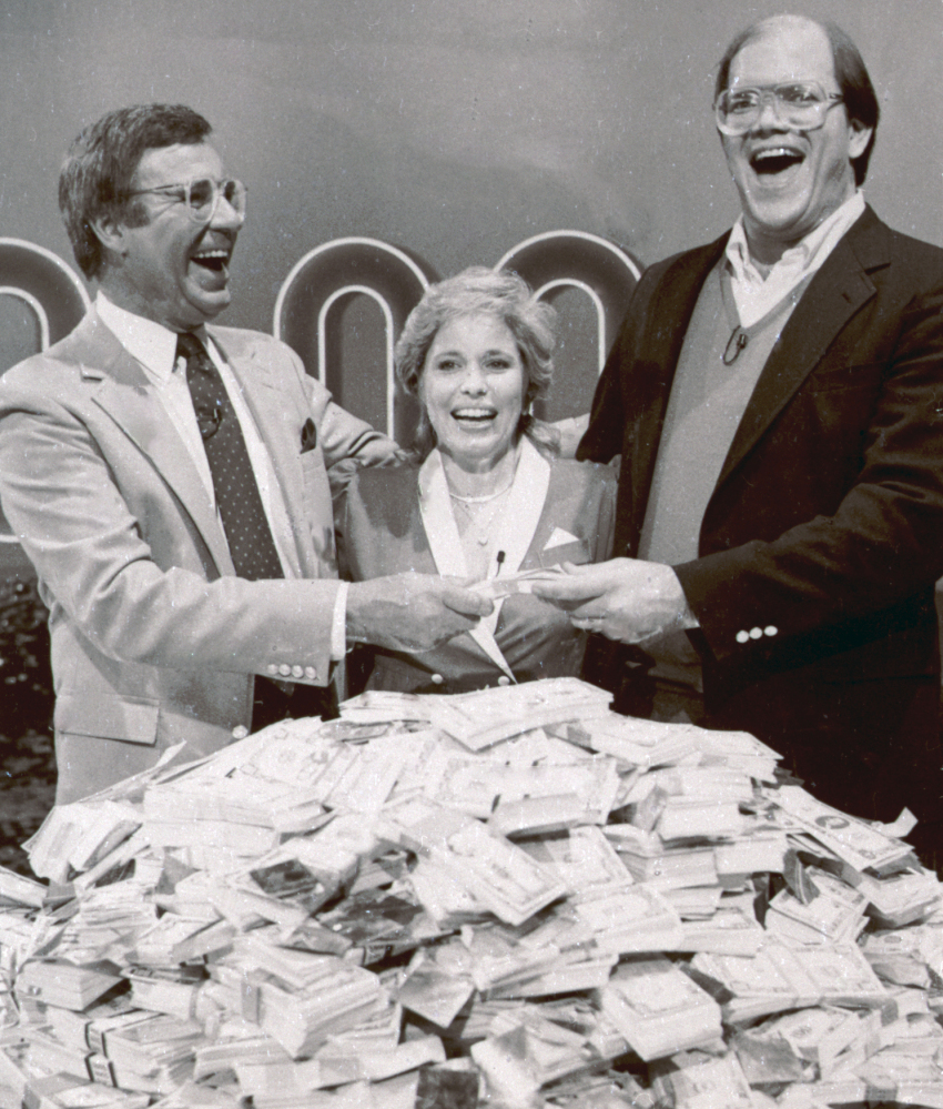 This 1986 photo shows host Jim Lange, left, congratulating Connie and Steve Rutenbar of Mission Viejo, Calif., after they won $1 million on the TV show “The $1,000,000 Chance of a Lifetime.”