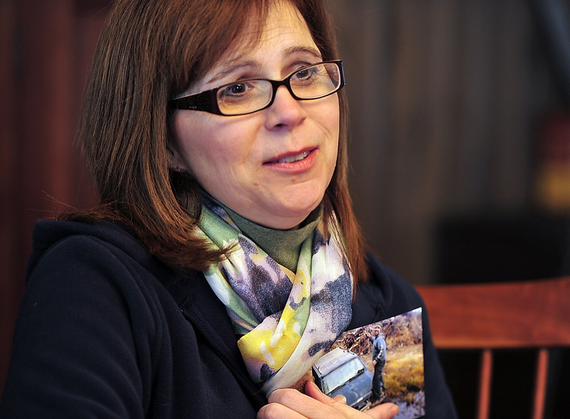 Theresa Allocca, mother of Tim Davison, who was shot in Pennsylvania, recounts the details of her son's shooting and the investigation Wednesday as she holds a photo of her son taken last summer at a camp near Turner. Wednesday, February 19, 2014. Gordon Chibroski, Staff Photographer