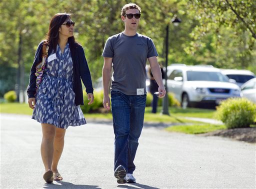 Mark Zuckerberg, president and CEO of Facebook, walks with Priscilla Chan in Sun Valley, Idaho in this 2011 file photo. The Chronicle of Philanthropy says the couple donated 18 million Facebook shares, valued at more than $970 million, to a Silicon Valley nonprofit in December.