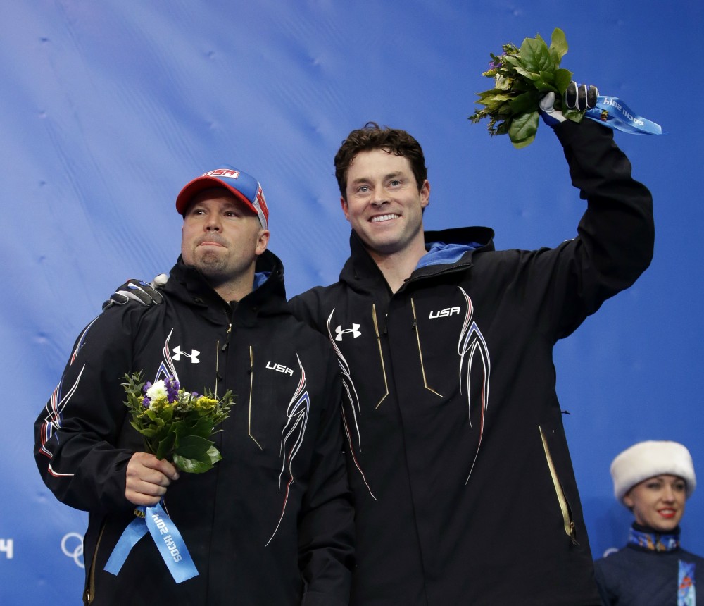 The team from the United States USA-1, piloted by Steven Holcomb and brakeman Steven Langton, celebrate their bronze medal win after the men's two-man bobsled competition at the 2014 Winter Olympics, Monday, Feb. 17, 2014, in Krasnaya Polyana, Russia. (AP Photo/Dita Alangkara) 2014 Sochi Olympic Games,Winter Olympic games,Olympic games,Sports,Events,XXII Olympic Winter Games