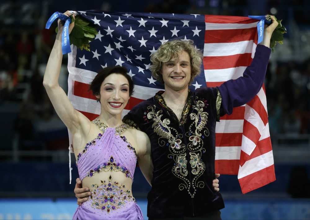 Meryl Davis and Charlie White of the United States pose for photographers with the U.S. flag after placing first in the ice dance free dance figure skating finals at the Iceberg Skating Palace during the 2014 Winter Olympics, Monday, Feb. 17, 2014, in Sochi, Russia. (AP Photo/Darron Cummings) 2014 Sochi Olympic Games,Winter Olympic games,Olympic games,Sports,Events,XXII Olympic Winter Games