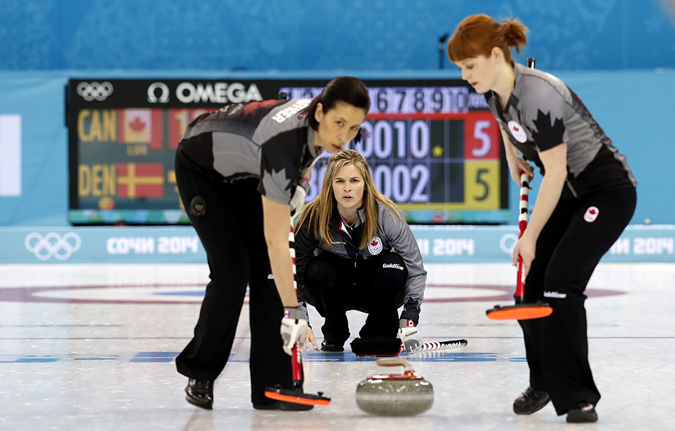Canada's skip Jennifer Jones, center, watches her teammates Jill Officer, left, and Dawn McEwen, right, during the women's curling competition against Denmark at the 2014 Winter Olympics, Thursday, Feb. 13, 2014, in Sochi, Russia. (AP Photo/Wong Maye-E) 2014 Sochi Olympic Games;Winter Olympic games;Olympic games;Spor