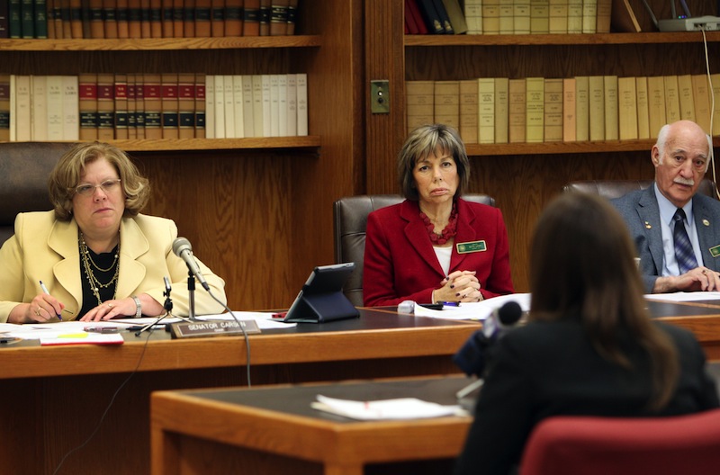 Members of the Senate Judiciary Committee, from left, Chair Sharon Carson, Bette Lasky, and Sam Cataldo listen to a rape victim during a hearing at the Statehouse in Concord, N.H. Tuesday Feb. 4, 2014. Lawmakers are considering a bill to terminate a parent's rights to a child if the child was conceived as a result of rape and the parent is convicted of the sexual assault.