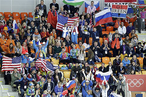 Fans wave their respective national flags and watch the women's 3,000-meter speedskating race at the Adler Arena Skating Center on Sunday during the 2014 Winter Olympics in Sochi, Russia. Many foreigners who have made it to Sochi fall into three camps: experienced world travelers who aren’t easily spooked, die-hard Olympic regulars.