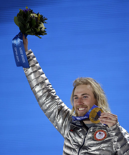 Gold medalist Sage Kotsenburg, of the United States, holds up his medal during the medal ceremony for the Snowboard Men's Slopestyle competition at the 2014 Winter Olympics, Saturday, Feb. 8, 2014, in Sochi, Russia.