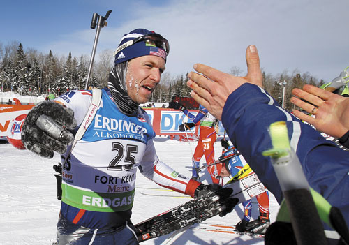 SHOCKER: Lowell Bailey, of Lake Placid, N.Y., accepts congratulations after finishing in ninth place in the men’s 15-kilometer mass start race Sunday at the Biathlon World Cup in Fort Kent. Bailey credited the local crowd with propelling him to a top 10 finish.