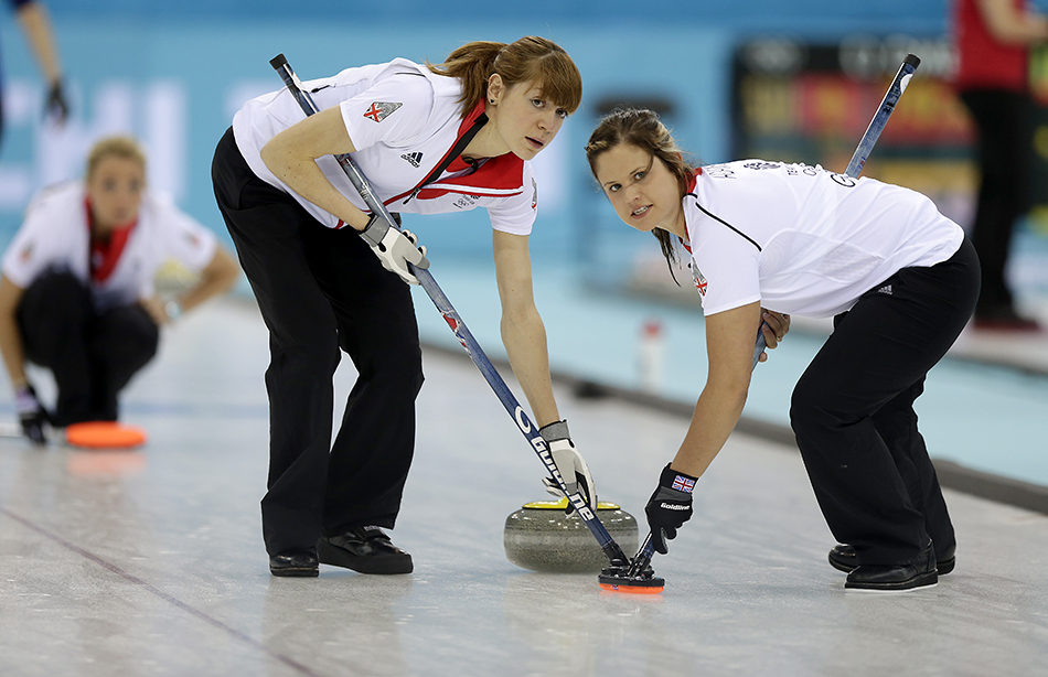 Great Britain's Claire Hamilton, right, and Anna Sloan, right, sweep the ice during the women's curling competition against Sweden at the 2014 Winter Olympics, Monday, Feb. 10, 2014, in Sochi, Russia. (AP Photo/Wong Maye-E) 2014 Sochi Olympic Games;Winter Olympic games;Olympic games;Spor