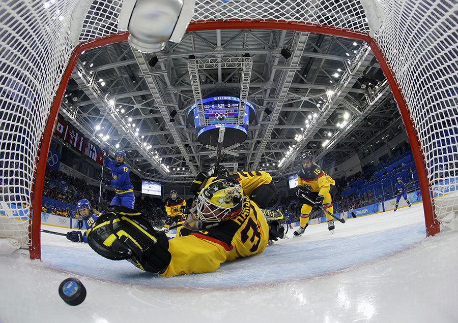 Germany's goalie Jennifer Harss watches the puck enter the net on a goal by Sweden's Johanna Olofsson (not seen) during the third period of their women's preliminary round hockey game at the Sochi 2014 Winter Olympic Games February 11, 2014.