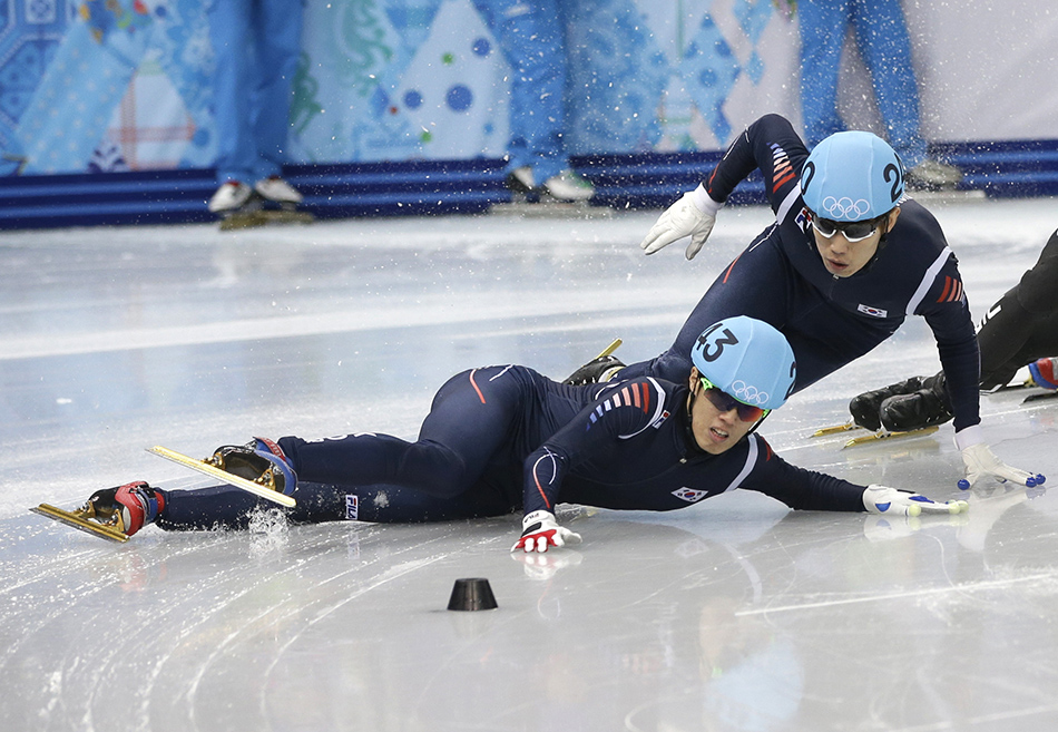 Sin Da-woon of South Korea, left, crashes as Lee Han-bin of South Korea goes down with him in a men's 1500m short track speedskating semifinal at the Iceberg Skating Palace during the 2014 Winter Olympics, Monday, Feb. 10, 2014, in Sochi, Russia. (AP Photo/Darron Cummings) 2014 Sochi Olympic Games;Winter Olympic games;Olympic games;Spor