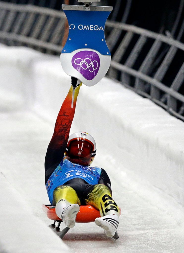 Germany's Felix Loch hits the relay pad so the doubles team can start during the luge team relay competition at the 2014 Winter Olympics, Thursday, Feb. 13, 2014, in Krasnaya Polyana, Russia. The German team won the gold medal.