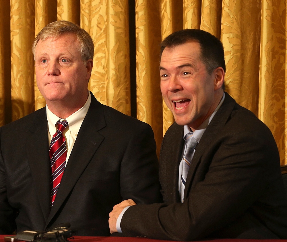 Gay couple Mark Phariss, left, and Victor Holmes, react during a news conference in San Antonio on Wednesday.