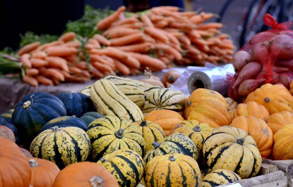 Harvest: A variety of squash stands on display Oct. 30, 2013, at the Portland Farmers Market. Clockwise from the bottom are sugar dumpling, pumpkins, acorn, delicata and golden acorns, arranged with carrots are in the background.