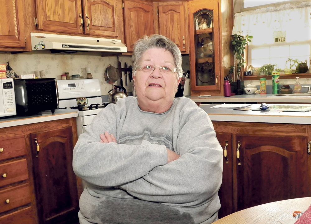 BAD NEWS: Judy Poulin, of Fairfield, shown at home Tuesday, said she was surprised and upset to hear about the suspension of the Farmshare program, which provides a subsidy to buy locally grown food. Poulin has been involved with the federal program for four years.