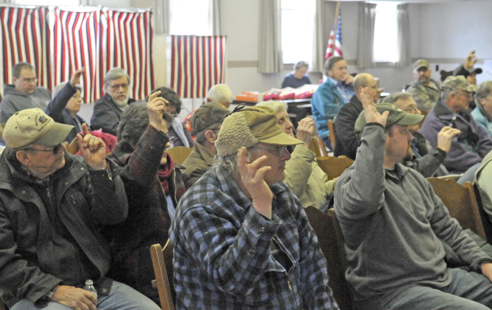 TOWN MEETING: Residents of Cornville vote on a motion during the annual Town Meeting at the Cornville Town Hall on Saturday.