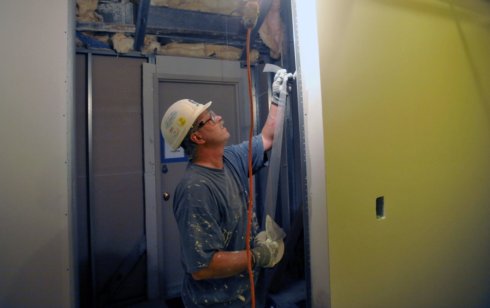 LAB WORK: David Chrissman, with Zimba Drywall works in the out-patient laboratory at the Thayer Center for Health in Waterville on Feb. 21, 2014.