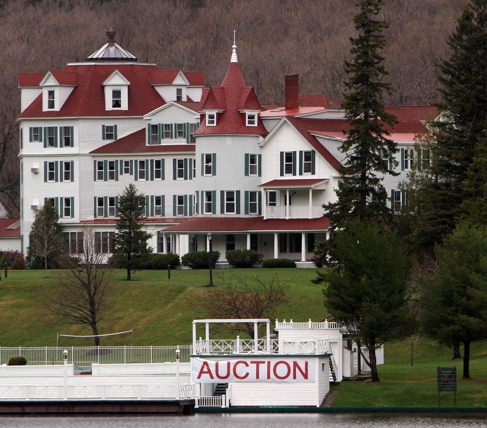 A large sign is seen in front of the Balsams Hotel in Dixeville Notch, N.H., prior to an auction to clear it out after it was sold to two businessmen for $2.3 million. They have since entered into an agreement with Les Otten to redevelop the property.