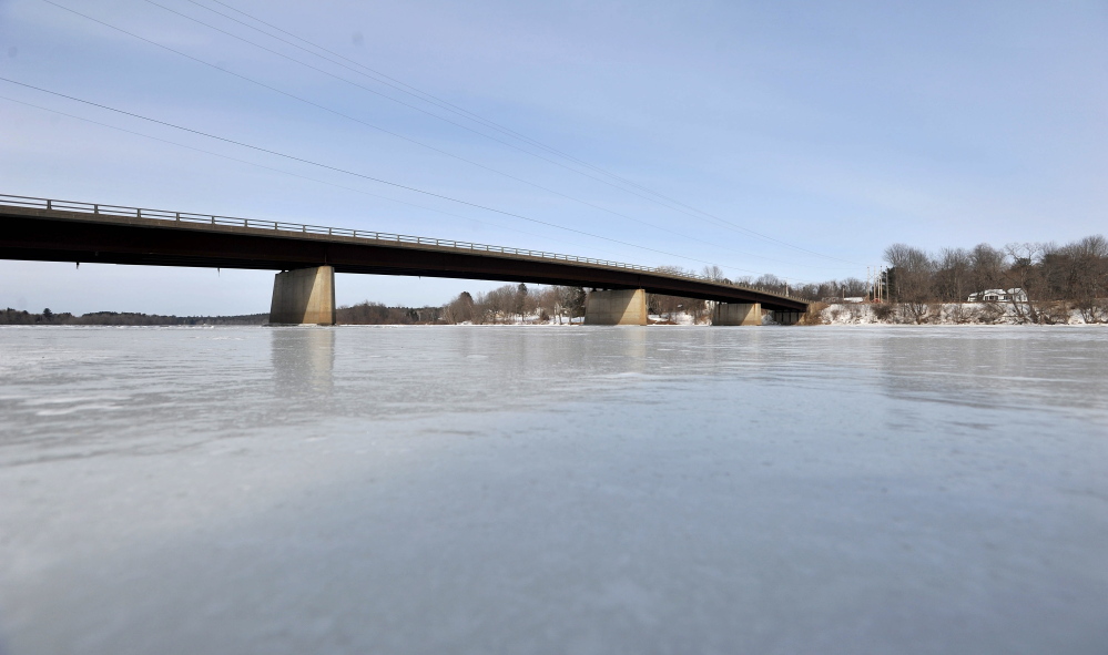 ICY RIVER: The Canaan Road bridge spans the frozen Kennebec River in Fairfield on Tuesday. Officials are keeping an eye on the rivers and hope to find out more soon about the likelihood of spring floods after this winter’s heavy snow and cold temperatures.