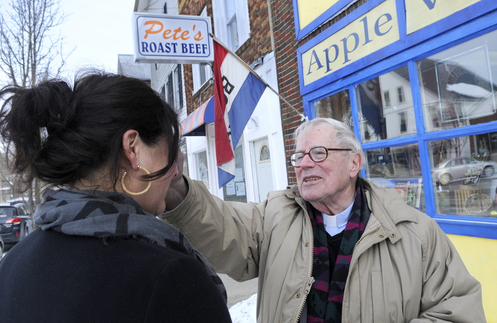 ASHES TO GO: The Rev. James Gill, of St. Andrew’s Episcopal Church, smudges ashes Wednesday on Kim Cognata’s forehead on the first day of Lent in downtown Winthrop. Gill took the ashes, a Christian symbol of repentance before God, to the streets as an extension of services at his Winthrop church. Cognata co-owns The Flaky Tart Cafe in Winthrop.