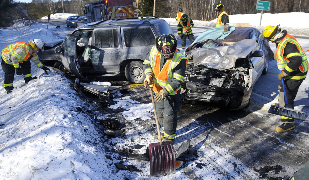 MONMOUTH CRASH: Monmouth firefighters collect debris from a two-car collision that killed a woman Thursday morning on U.S. Route 202 in Monmouth.