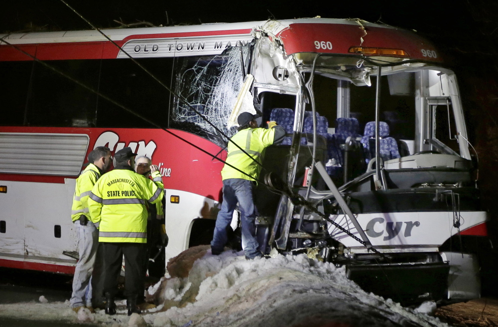 Massachusetts State Police examine the bus that was carrying the University of Maine women’s basketball team when it crashed last year on Interstate 95 north of Boston.