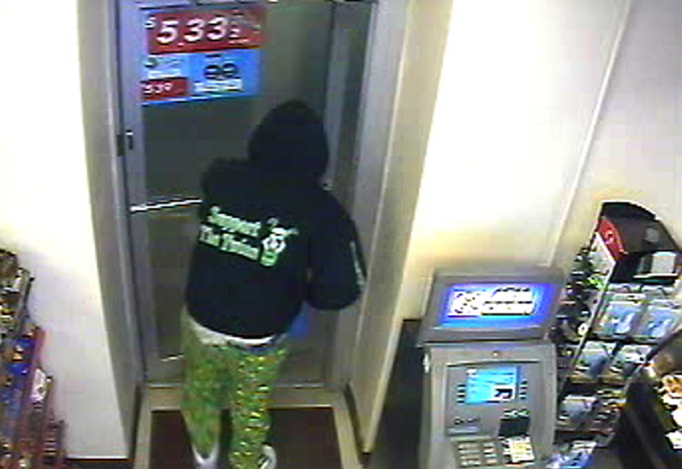Convenience store Robbery: Surveillance camera photo of suspected armed robber.