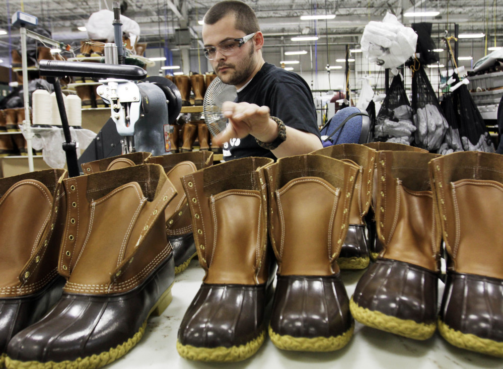 Eric Rego assembles boots in L.L. Bean’s Brunswick plant. The company reports strong sales of its boots as part of its increase in revenues.
